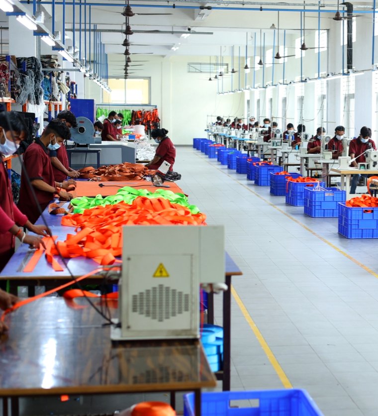 SB stitching floor in Kanpur, staff working with orange harness webbing