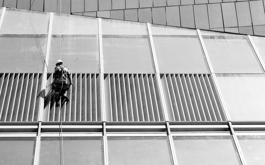 Rope access technicians working suspended on a building facade