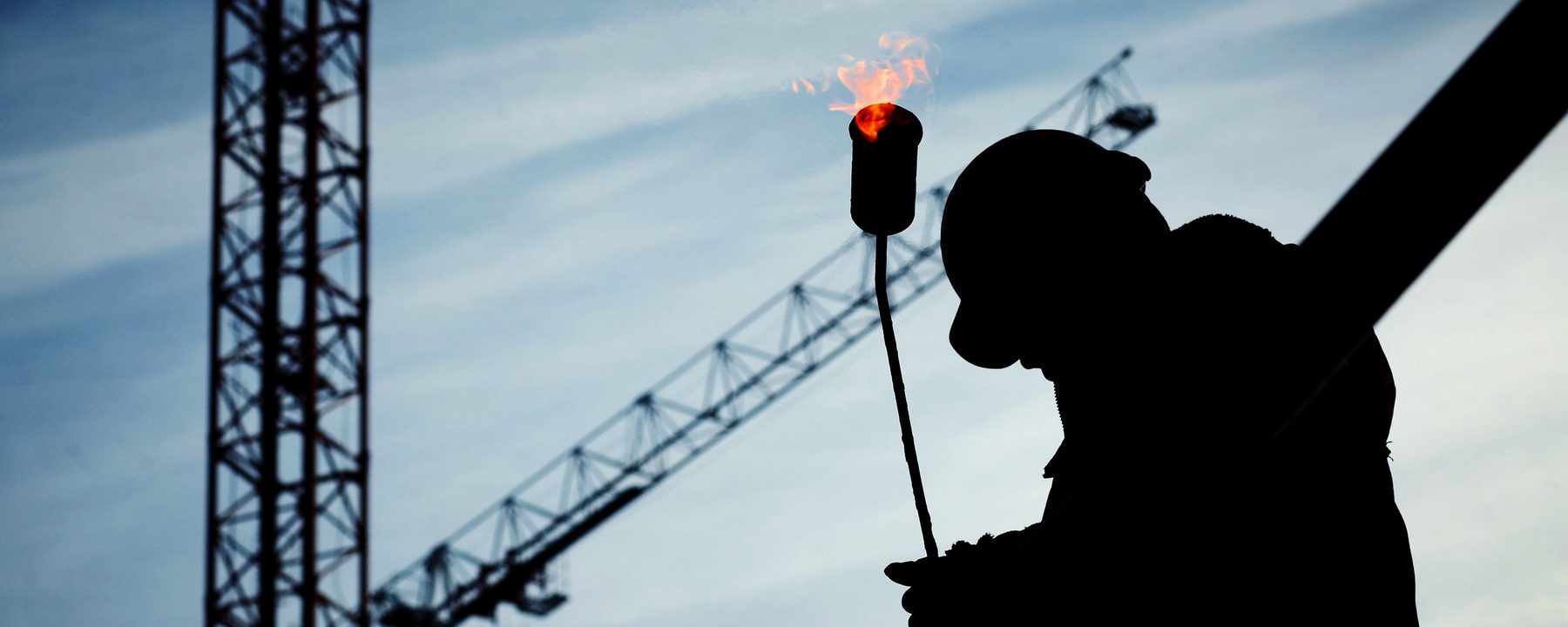Technician inspecting industrial equipment in a manufacturing plant