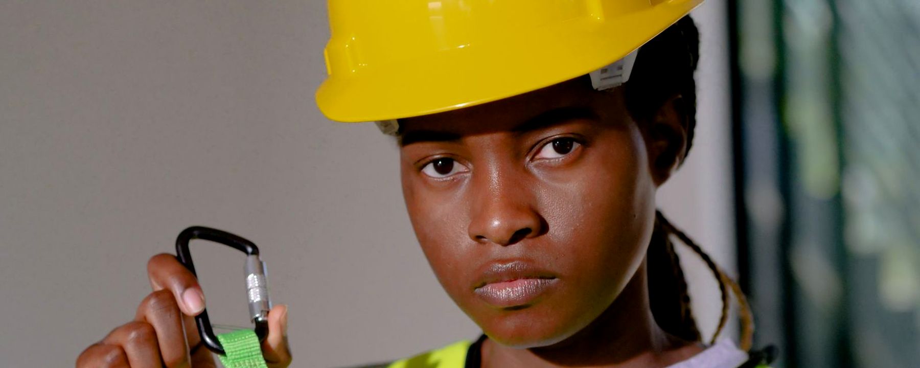 Worker checking a carabiner and lanyard before starting work